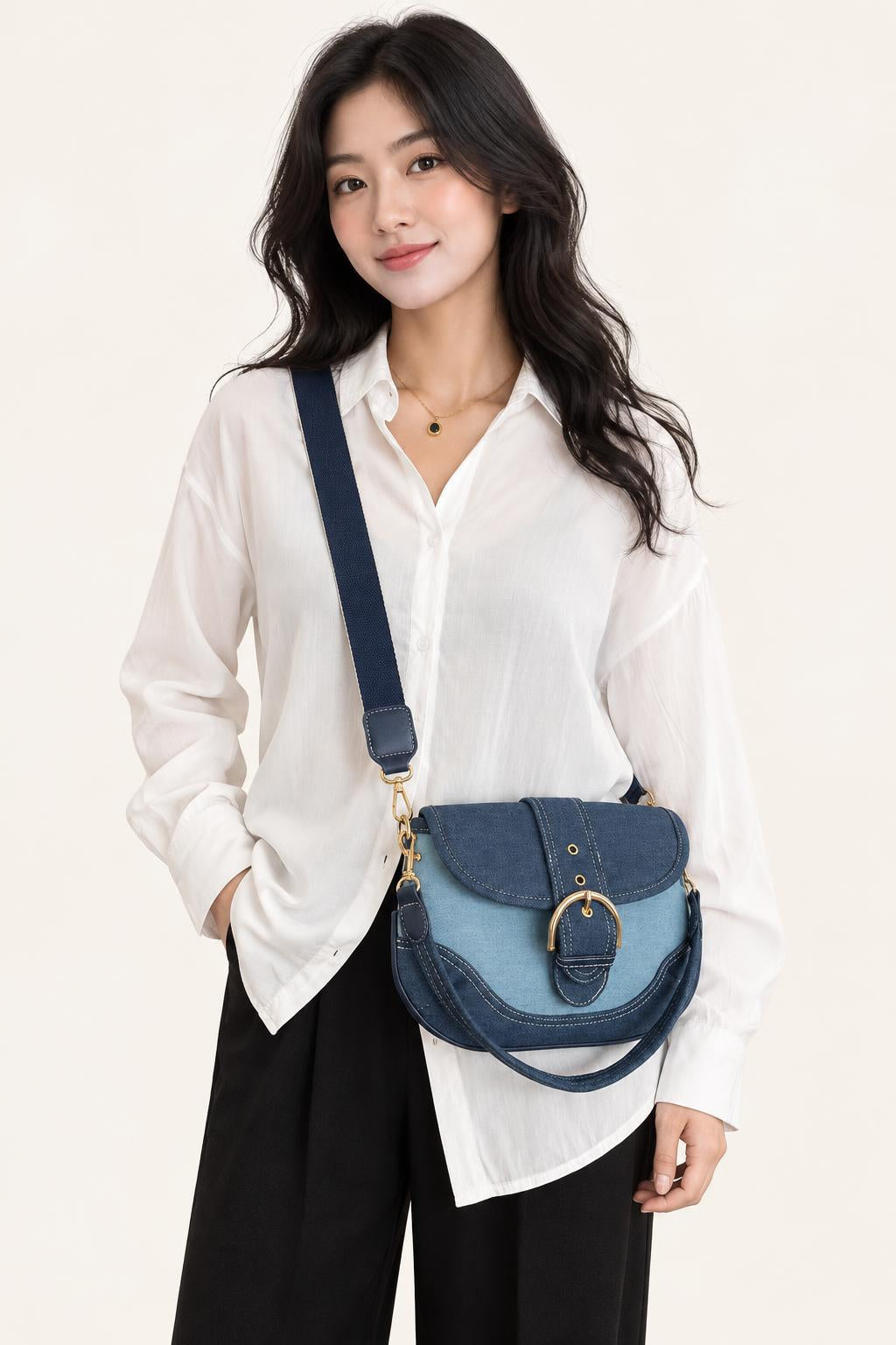 Denim Saddle Shoulder & Crossbody Bag — carrying view